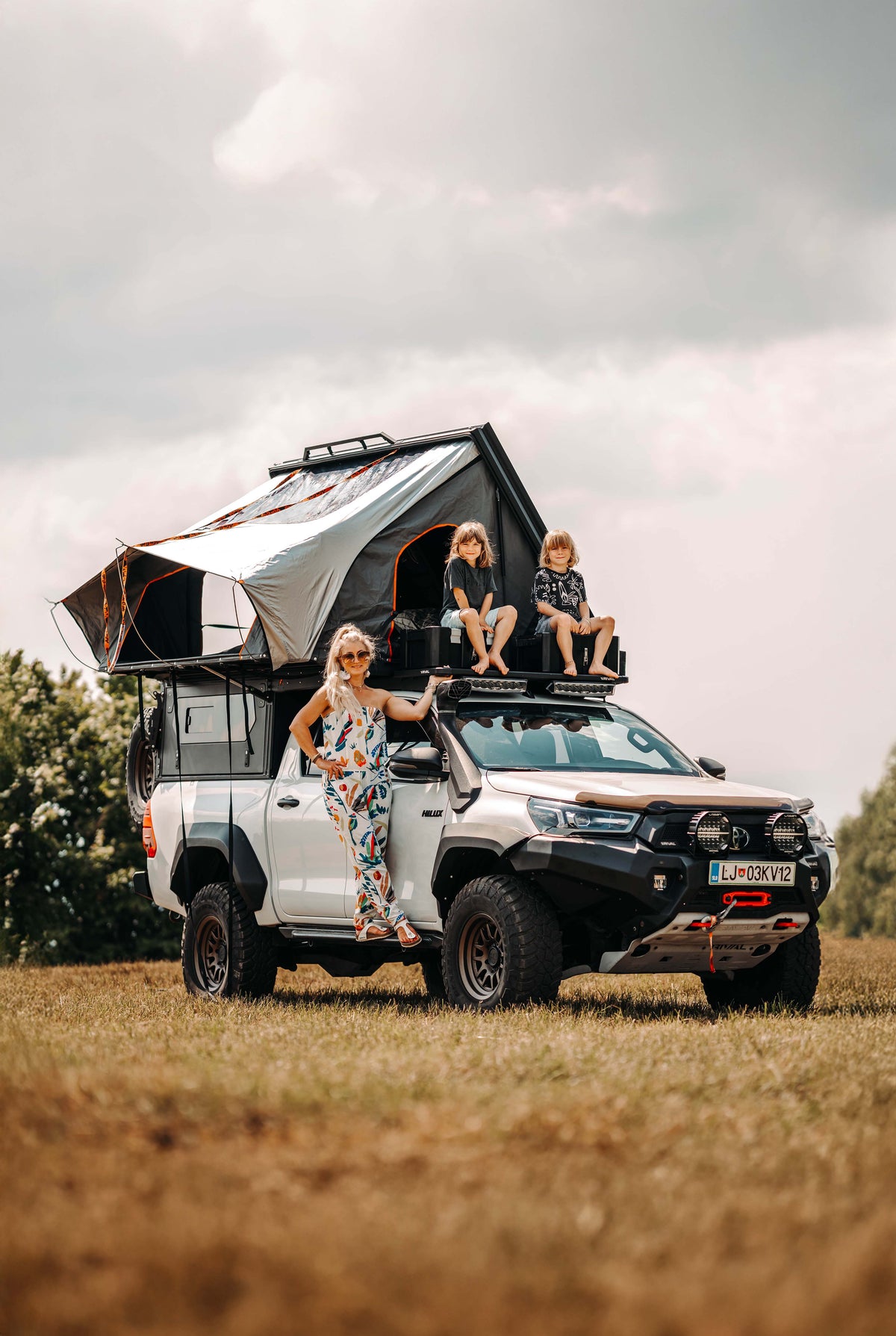 Toyota Hilux Invincible equipped with Alu-Cab Modcap and family shot with the car